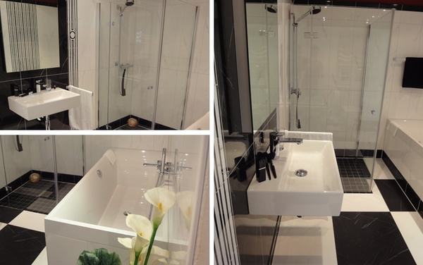 Modernes Badezimmer mit ebenerdiger Dusche, Badewanne, Waschbecken und stilvollen Fliesen.